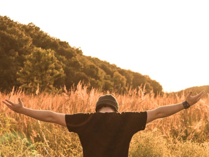 man standing in the middle of field in abandonment