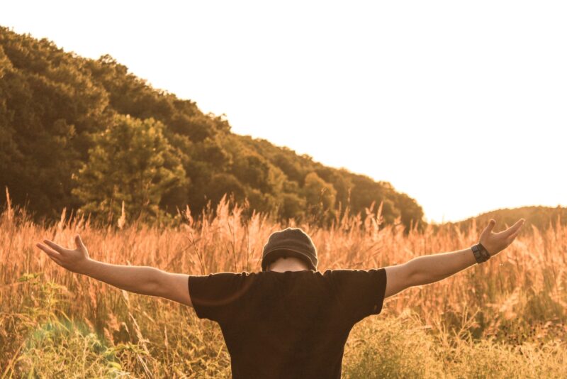 man standing in the middle of field in abandonment