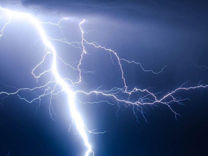 A power lightning strike during blue sky