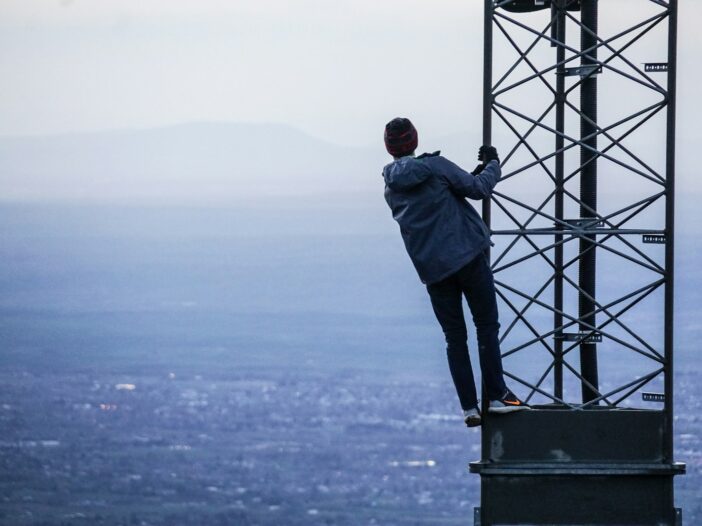 man climbing on tower with an obfuscated view.