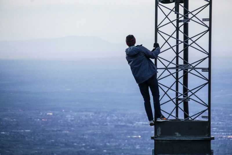 man climbing on tower with an obfuscated view.