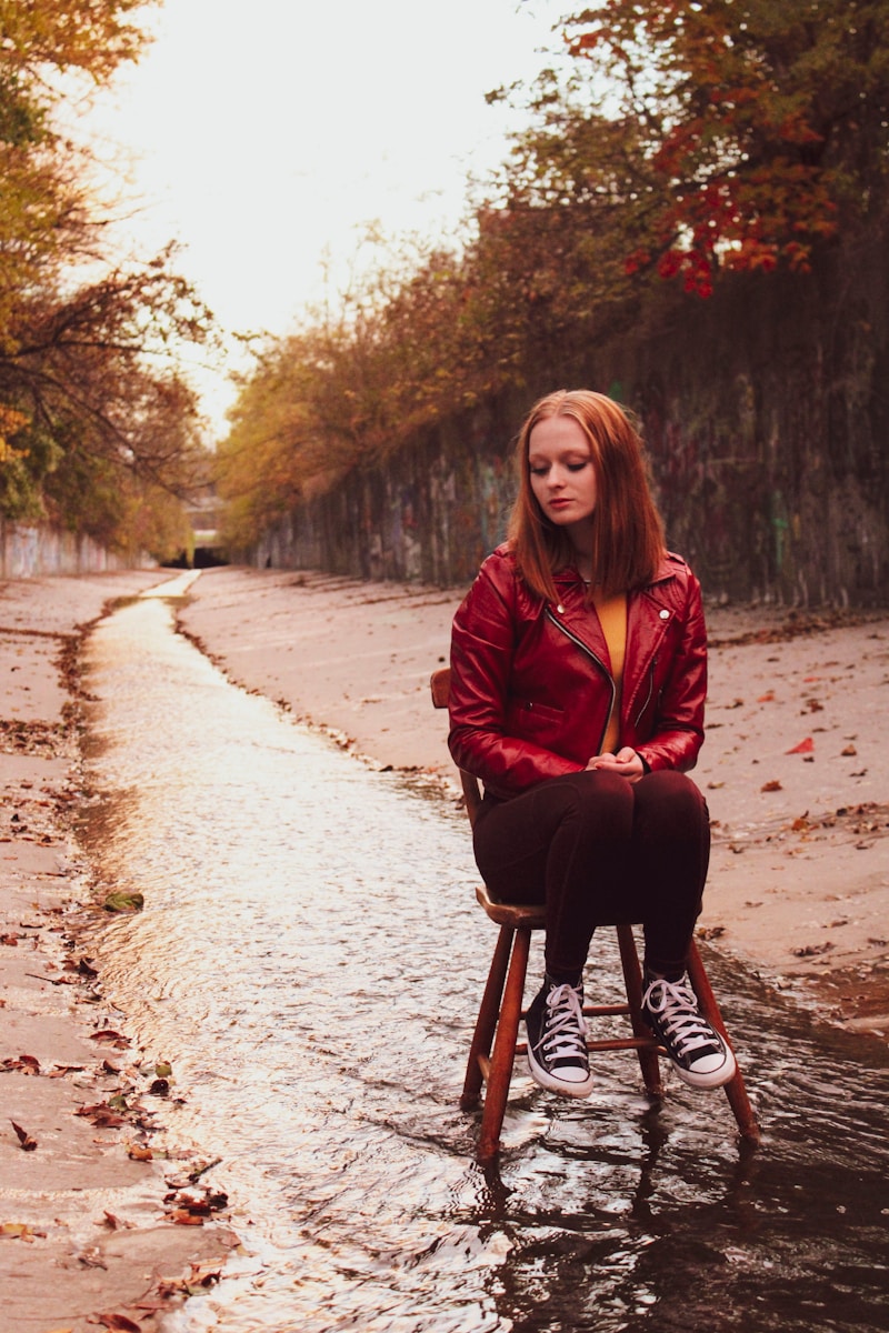 a woman sitting on a chair in the water. It is draining.