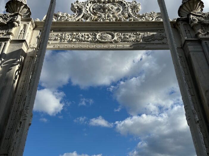 A large gate with a sky in the background